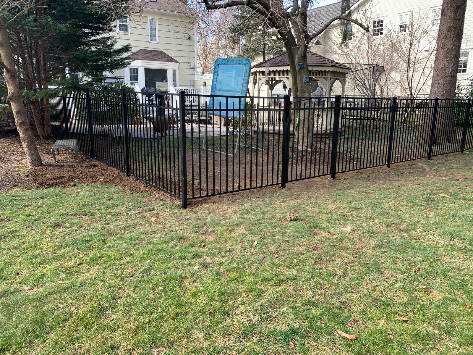 Ornamental fence enclosing a backyard play area